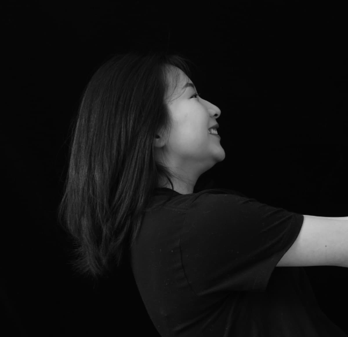 Black and white profile portrait of Sherry, smiling